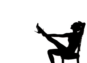 silhouette of pretty stripper on a chair